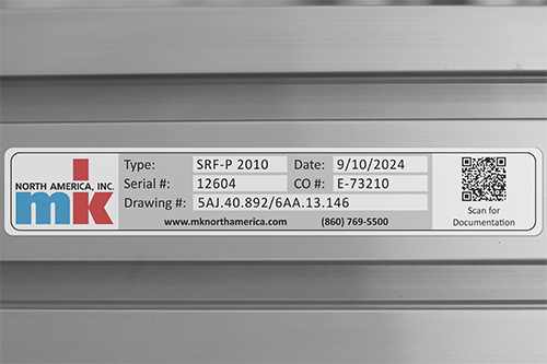 An mk serial number label, with QR code mounted on to the side of a conveyor.