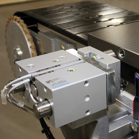 pallet locating device on a covneyor